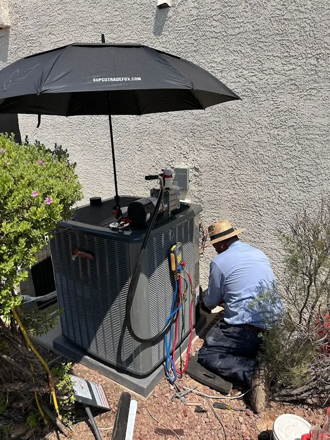 HVAC technician performing outdoor AC maintenance in Richmond